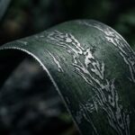 The leaf looks like green architectural steel with silver patterns
